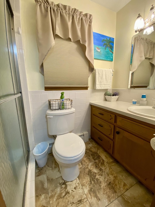 1605 S Park Ave, Aurora, MO 65605 - full bath featuring vanity, a shower stall, tile walls, and a wainscoted wall