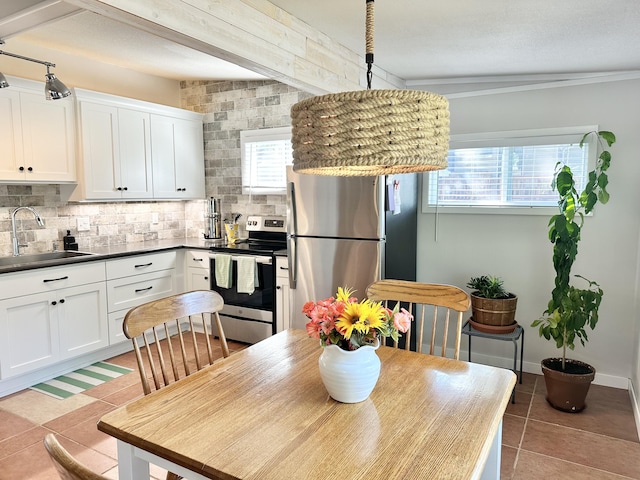 25795 Canyon Dr, Hermitage, MO 65668 - kitchen with appliances with stainless steel finishes, decorative backsplash, white cabinetry, and light tile patterned floors