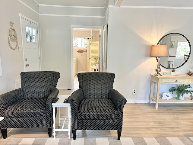 25795 Canyon Dr, Hermitage, MO 65668 - living area featuring wood finished floors, plenty of natural light, and ornamental molding