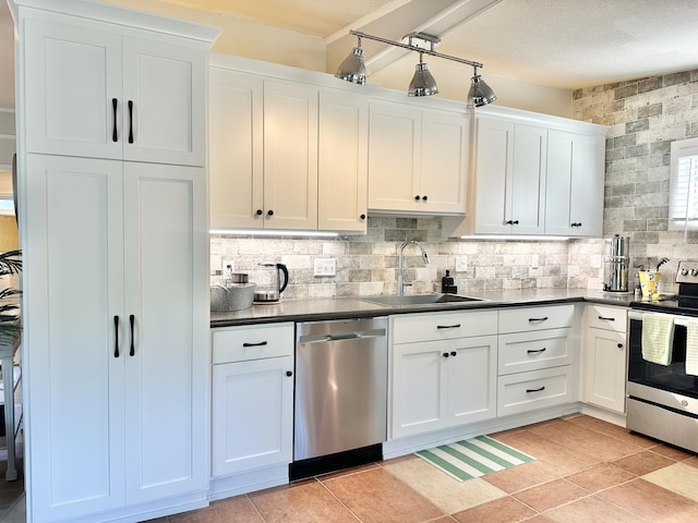 25795 Canyon Dr, Hermitage, MO 65668 - kitchen featuring appliances with stainless steel finishes, dark countertops, white cabinetry, tasteful backsplash, and light tile patterned flooring