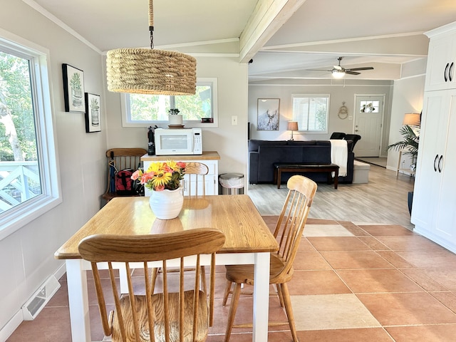 25795 Canyon Dr, Hermitage, MO 65668 - dining space with plenty of natural light, ceiling fan, beam ceiling, ornamental molding, and light tile patterned flooring