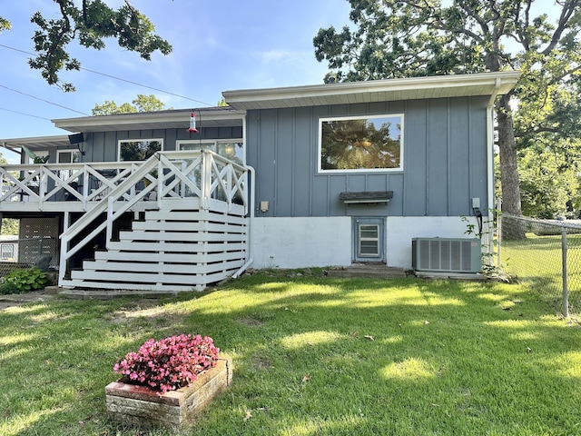 25795 Canyon Dr, Hermitage, MO 65668 - rear view of house featuring a deck, board and batten siding, and stairway