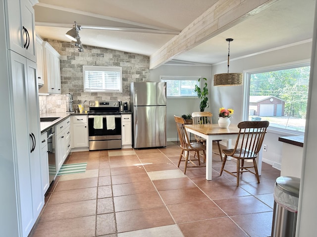 25795 Canyon Dr, Hermitage, MO 65668 - kitchen with stainless steel appliances, white cabinetry, beam ceiling, tasteful backsplash, and dark countertops