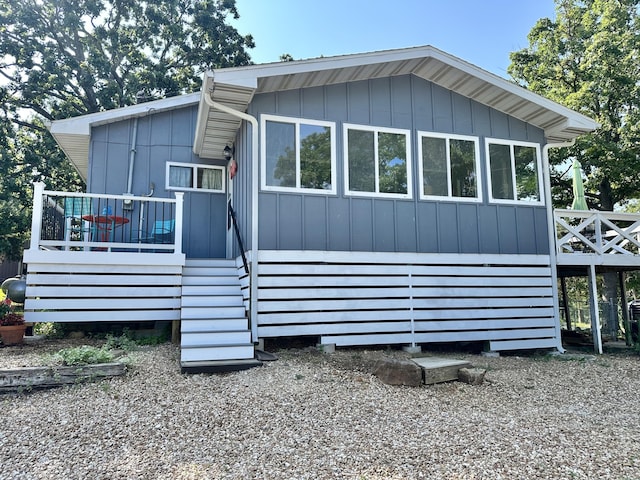 25795 Canyon Dr, Hermitage, MO 65668 - view of front facade with a wooden deck and stairway