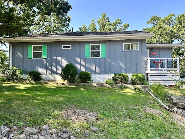 25795 Canyon Dr, Hermitage, MO 65668 - view of home's exterior with board and batten siding and a lawn