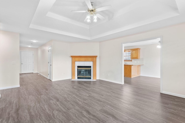 604 N Ellen St, Nixa, MO 65714 - unfurnished living room featuring a tray ceiling, ceiling fan, and a tile fireplace
