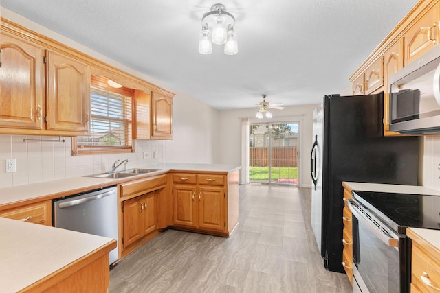 604 N Ellen St, Nixa, MO 65714 - kitchen with stainless steel appliances, a peninsula, light countertops, and tasteful backsplash