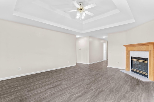 604 N Ellen St, Nixa, MO 65714 - unfurnished living room featuring a tray ceiling, a tiled fireplace, and a ceiling fan