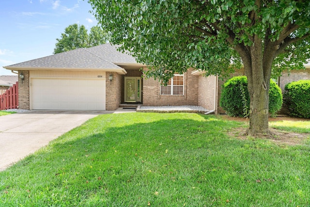 604 N Ellen St, Nixa, MO 65714 - view of front of home featuring an attached garage, concrete driveway, brick siding, and roof with shingles