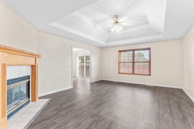 604 N Ellen St, Nixa, MO 65714 - unfurnished living room featuring a tray ceiling, ceiling fan, and a tiled fireplace