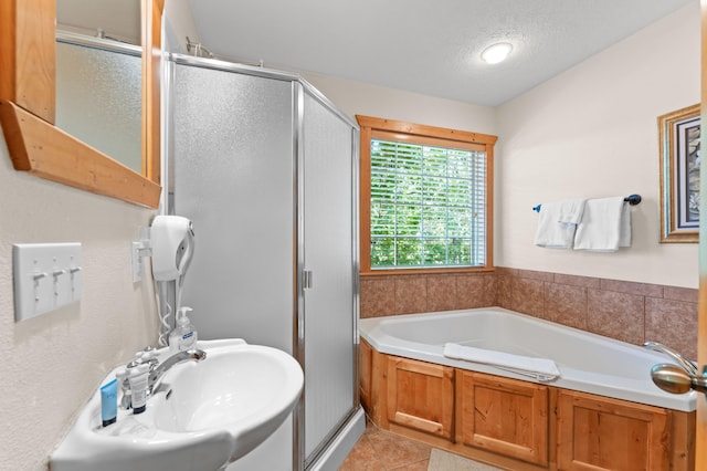 23 Olivia Ct Unit 103A, Branson West, MO 65737 - full bath with a stall shower, a bath, tile patterned floors, and a textured ceiling