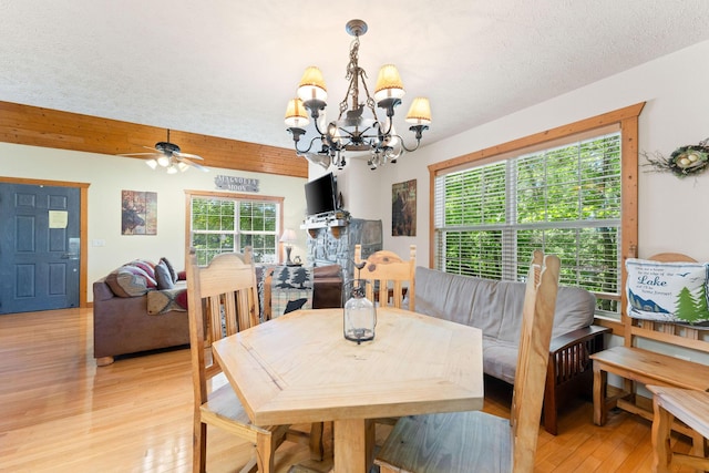 23 Olivia Ct Unit 103A, Branson West, MO 65737 - dining area featuring a chandelier, light wood-type flooring, healthy amount of natural light, and ceiling fan