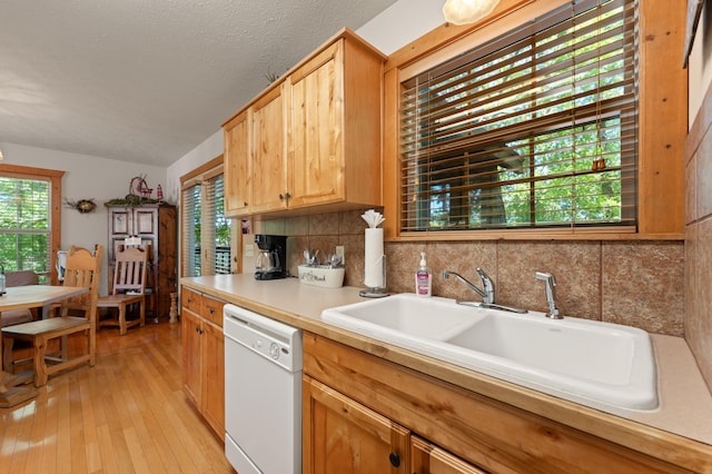 23 Olivia Ct Unit 103A, Branson West, MO 65737 - kitchen with white dishwasher, light wood-type flooring, light countertops, and decorative backsplash
