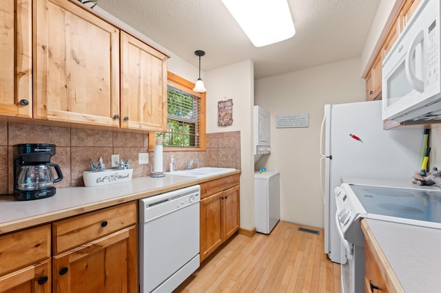 23 Olivia Ct Unit 103A, Branson West, MO 65737 - kitchen featuring white appliances, light wood-style flooring, backsplash, light countertops, and hanging light fixtures