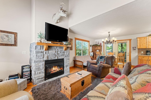 23 Olivia Ct Unit 103A, Branson West, MO 65737 - living area with a chandelier, wood finished floors, and a fireplace