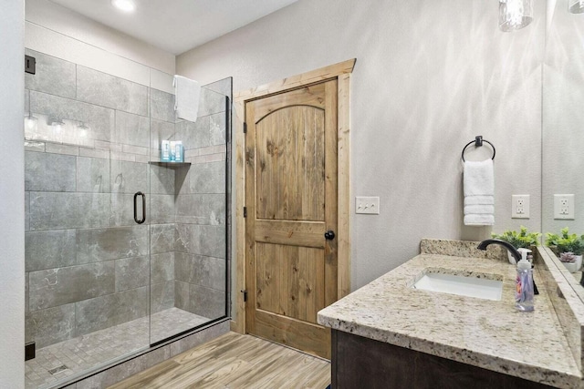 208 Jax Trl, Branson, MO 65616 - bathroom with vanity, a stall shower, and wood finished floors