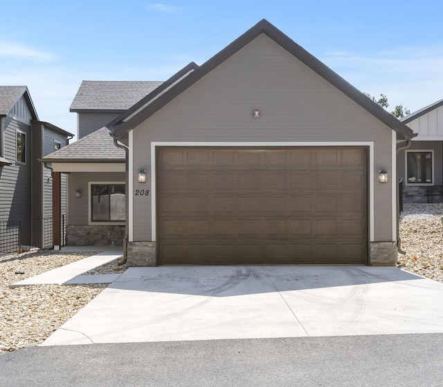208 Jax Trl, Branson, MO 65616 - view of front facade with stone siding, an attached garage, driveway, and a shingled roof