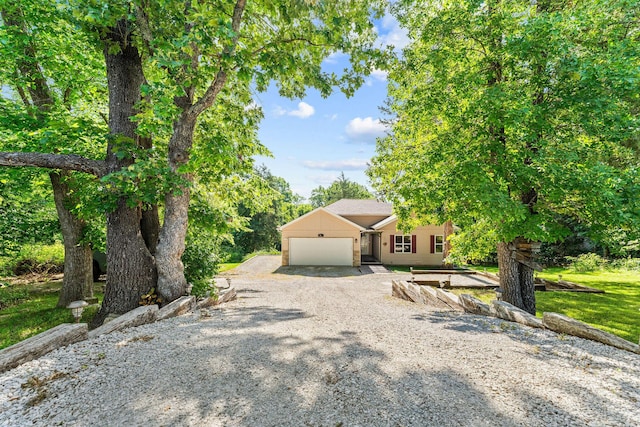 519 Iowa Colony Rd, Hollister, MO 65672 - view of front of property with a garage and gravel driveway