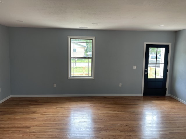 1506 6th St, Monett, MO 65708 - entryway with plenty of natural light and wood finished floors