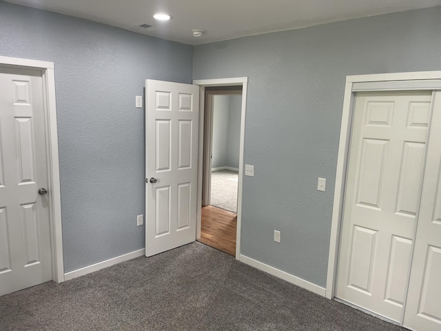 1506 6th St, Monett, MO 65708 - unfurnished bedroom featuring dark colored carpet and baseboards