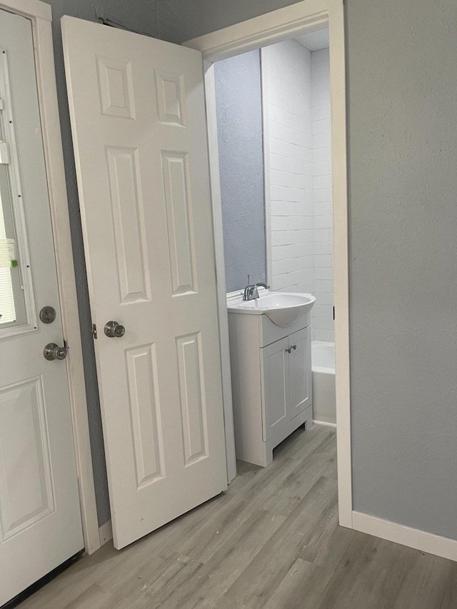1506 6th St, Monett, MO 65708 - full bath with wood finished floors, a tub, and vanity