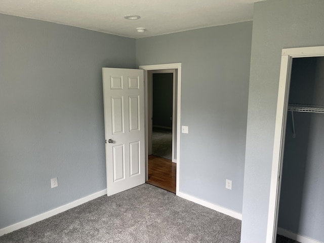 1506 6th St, Monett, MO 65708 - unfurnished bedroom with dark colored carpet and a closet