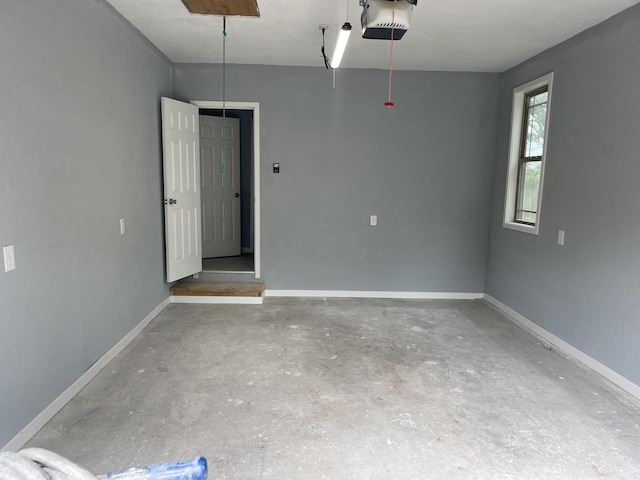 1506 6th St, Monett, MO 65708 - garage with baseboards and a garage door opener