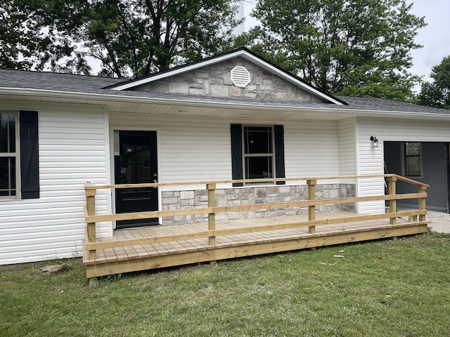 1506 6th St, Monett, MO 65708 - rear view of house featuring stone siding, a lawn, and a shingled roof