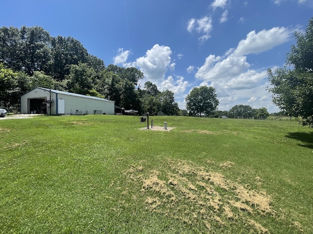 289 Backyard St, Crane, MO 65633 - view of green lawn featuring an outbuilding, an outdoor structure, and a garage