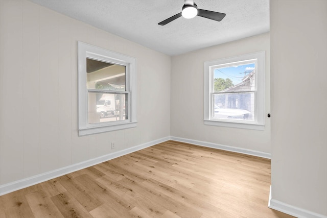 936 W Division St, Springfield, MO 65803 - spare room featuring light wood-style floors, a textured ceiling, and a ceiling fan