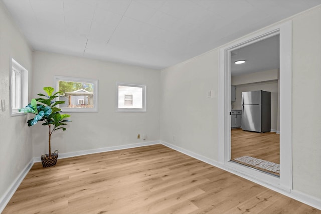 936 W Division St, Springfield, MO 65803 - empty room featuring light wood-style flooring and baseboards
