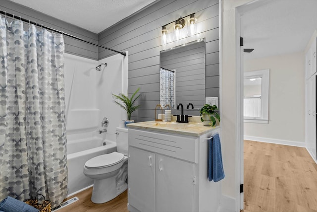936 W Division St, Springfield, MO 65803 - full bathroom with wood finished floors, vanity, shower / tub combo with curtain, a textured ceiling, and wooden walls