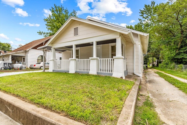 936 W Division St, Springfield, MO 65803 - view of front of house with covered porch, driveway, and a front lawn