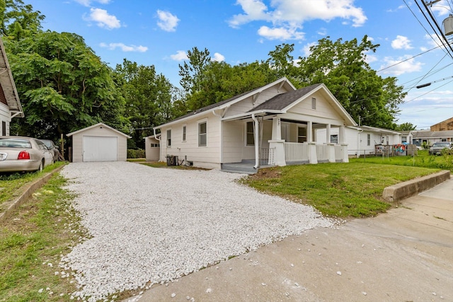 936 W Division St, Springfield, MO 65803 - bungalow featuring a porch, an outdoor structure, a garage, gravel driveway, and a front yard