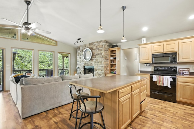 22562 Air Park Dr, Golden, MO 65658 - kitchen featuring black appliances, light wood-type flooring, open floor plan, a ceiling fan, and vaulted ceiling