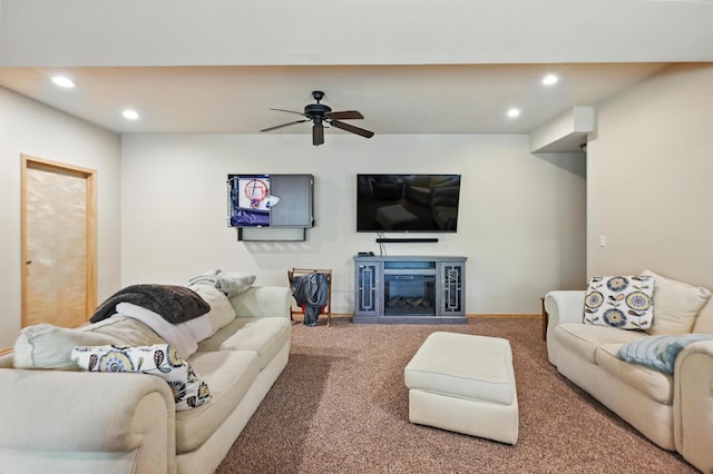 22562 Air Park Dr, Golden, MO 65658 - carpeted living room with recessed lighting, a glass covered fireplace, and a ceiling fan