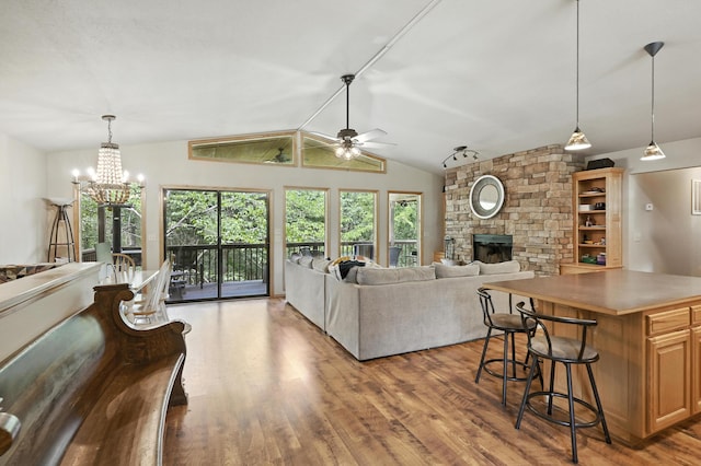22562 Air Park Dr, Golden, MO 65658 - living area featuring ceiling fan, a fireplace, wood finished floors, a chandelier, and lofted ceiling