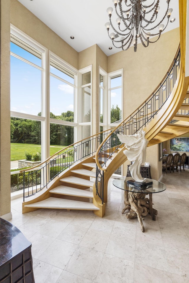 318 S Farm Rd Unit 193, Springfield, MO 65809 - stairway with plenty of natural light, a chandelier, and a towering ceiling