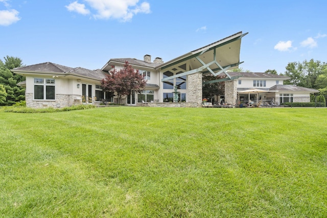 318 S Farm Rd Unit 193, Springfield, MO 65809 - rear view of house featuring stone siding, a chimney, a yard, and stucco siding