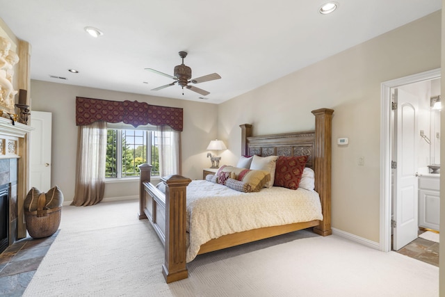 318 S Farm Rd Unit 193, Springfield, MO 65809 - bedroom with a tile fireplace, carpet, recessed lighting, a ceiling fan, and ensuite bath