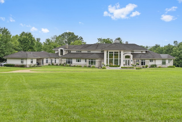 318 S Farm Rd Unit 193, Springfield, MO 65809 - view of front of house featuring stone siding, a chimney, and a front yard