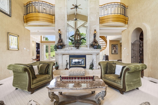 318 S Farm Rd Unit 193, Springfield, MO 65809 - living area with a high ceiling, arched walkways, ceiling fan, carpet, and a textured wall