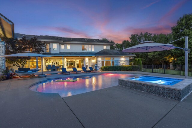 318 S Farm Rd Unit 193, Springfield, MO 65809 - pool at dusk with an in-ground hot tub and a patio