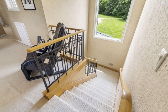 318 S Farm Rd Unit 193, Springfield, MO 65809 - staircase featuring carpet floors and a textured wall