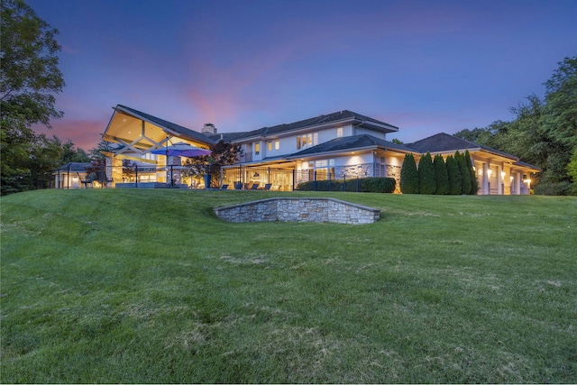 318 S Farm Rd Unit 193, Springfield, MO 65809 - back of house at dusk featuring a yard