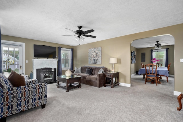 1841 E Dale St, Springfield, MO 65803 - carpeted living area featuring a ceiling fan, arched walkways, and a textured ceiling