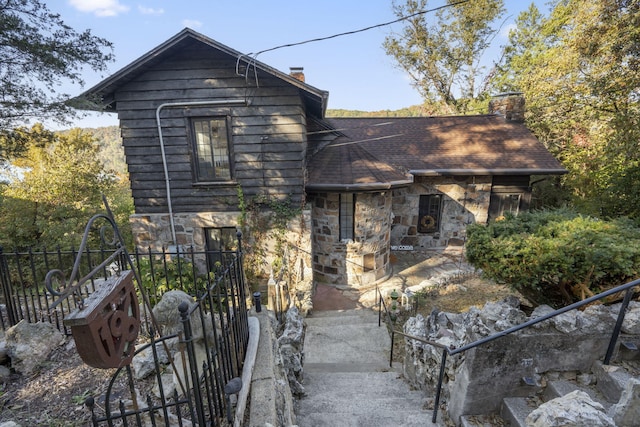 196 Lakeside Way, Forsyth, MO 65653 - view of front facade with stone siding, a chimney, and roof with shingles