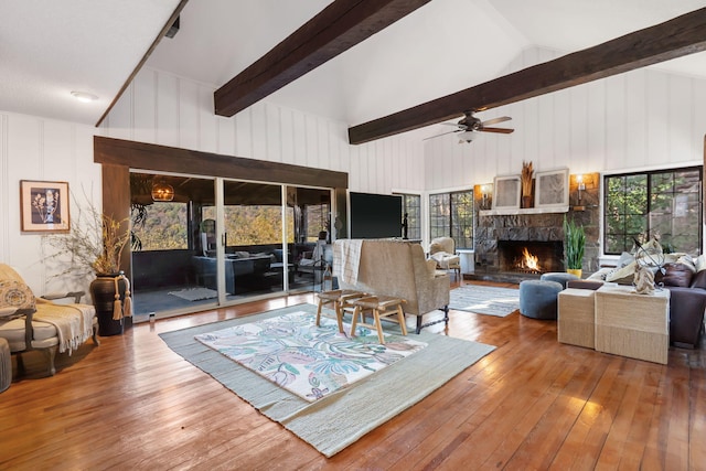 196 Lakeside Way, Forsyth, MO 65653 - living area with a fireplace, hardwood / wood-style flooring, ceiling fan, and wooden walls