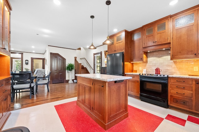933 W Pershing St, Springfield, MO 65806 - kitchen featuring black appliances, brown cabinets, recessed lighting, backsplash, and a center island