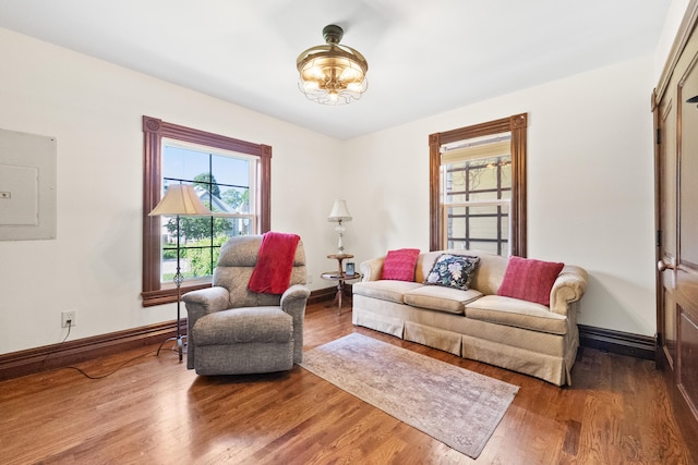 933 W Pershing St, Springfield, MO 65806 - living area with electric panel, wood finished floors, and a chandelier